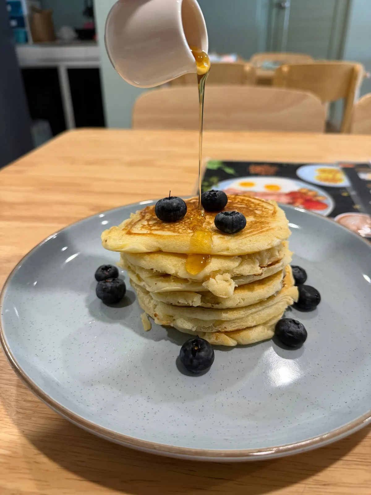 Maple syrup pour on blueberry American pancakes