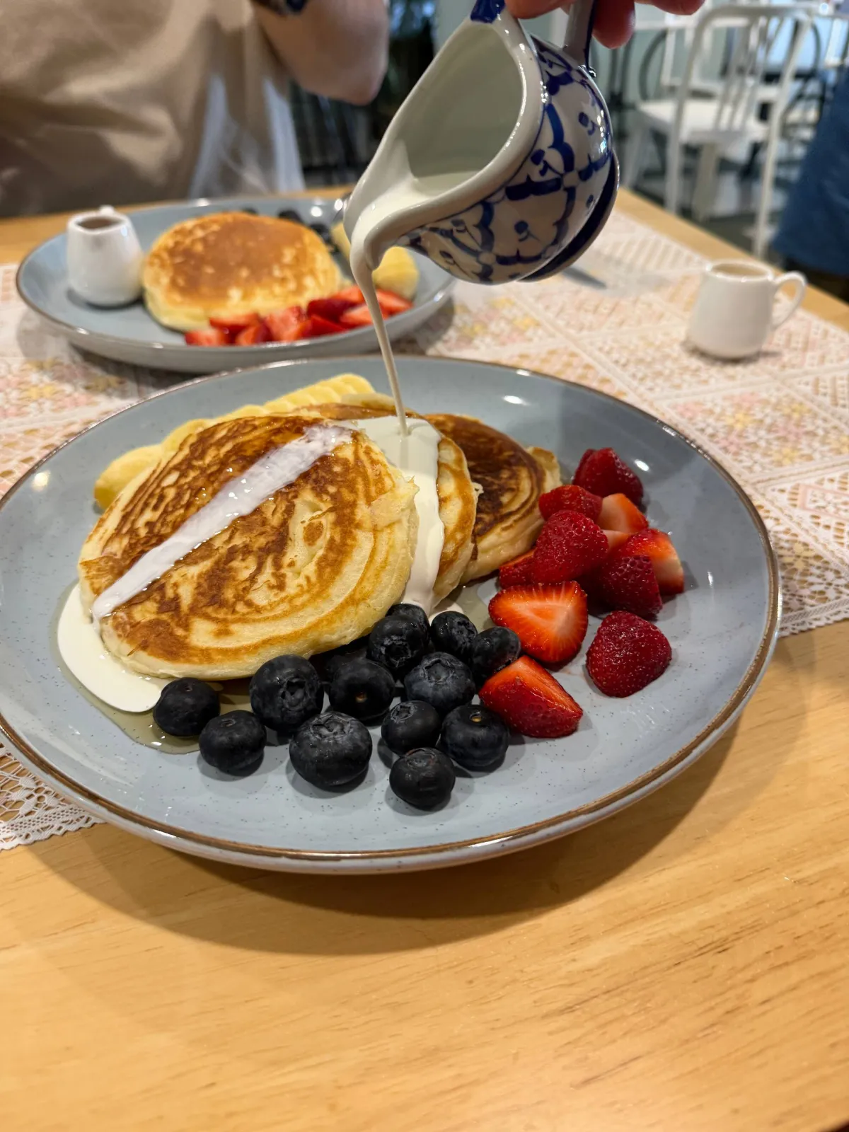 Fresh cream on berry pancakes The Lunch Box Cafe