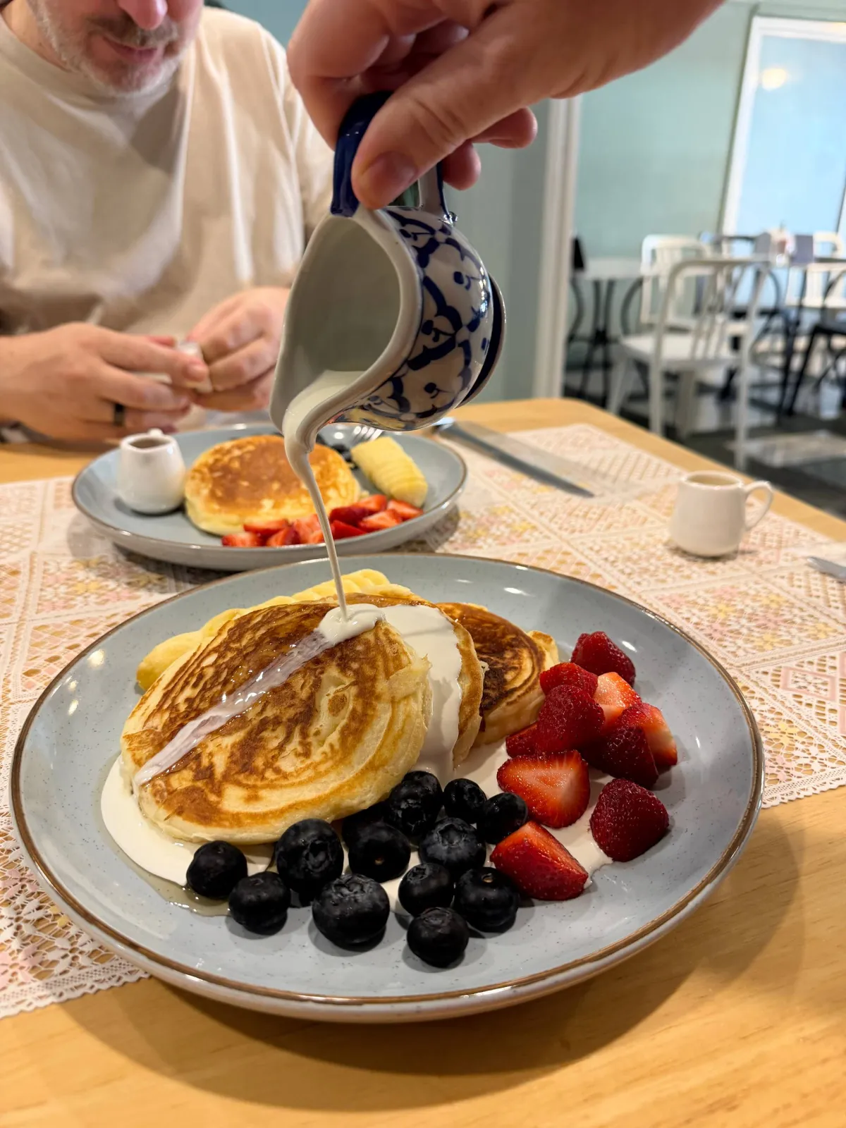 Fresh cream pour on American pancakes The Lunch Box Cafe